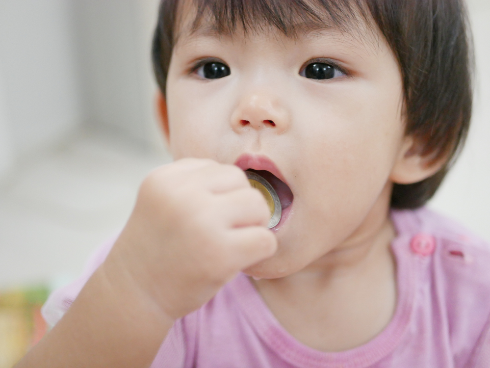Kid Eating Small Toy