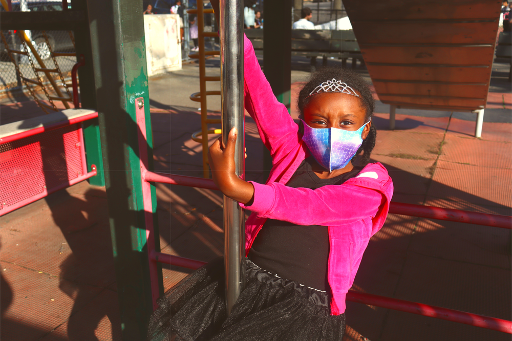 Kid Wearting a MAsk Playing