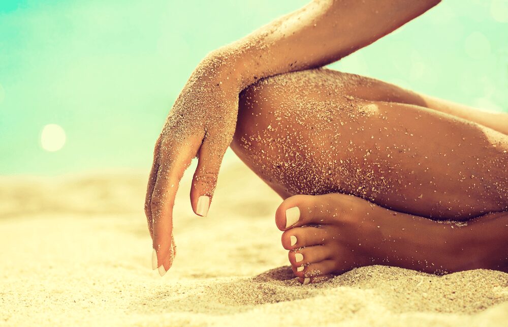 Person sitting on a sandy beach
