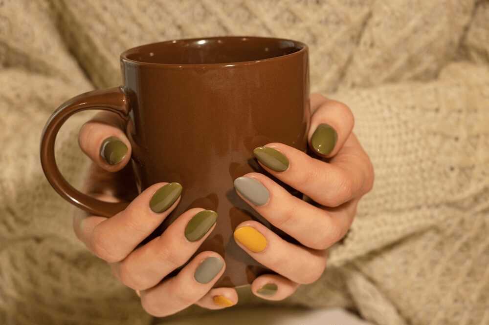 Lady with Acrylic Nails holding a cup