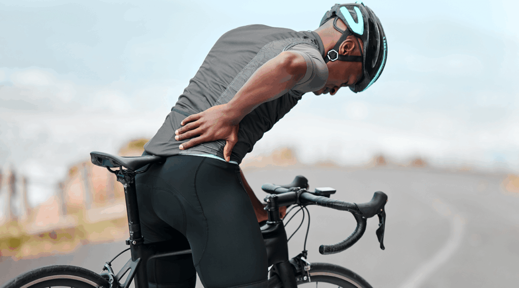 Black man with lower back pain from cycling